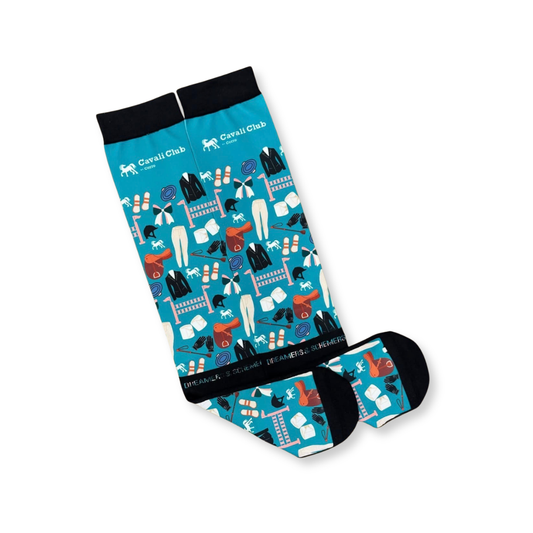 A pair of knee-high socks from Cavaill Club, featuring a vibrant blue background with a detailed graphic pattern of clothing items, shoes, and accessories, finished with solid black cuffs and toes.